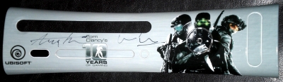 This is an official Tom Clancy's 10 Years of Gaming faceplate, autographed by Ubisoft North America President Laurent Detoc and Marketing Senior VP Tony Key. It was signed at a Ubisoft Kinect event held in San Francisco, CA in October, 2010.
