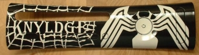 This plate includes the owner's gamertag and was painted in a style like the Marvel character Venom. The plate was white, the letters and logo were covered over with stickers, and the webbing was painted on with liquid latex. THe plate was sprayed black and once dry, the stickers were removed and the latex was rolled off with the thumb, leaving the crude webbing.